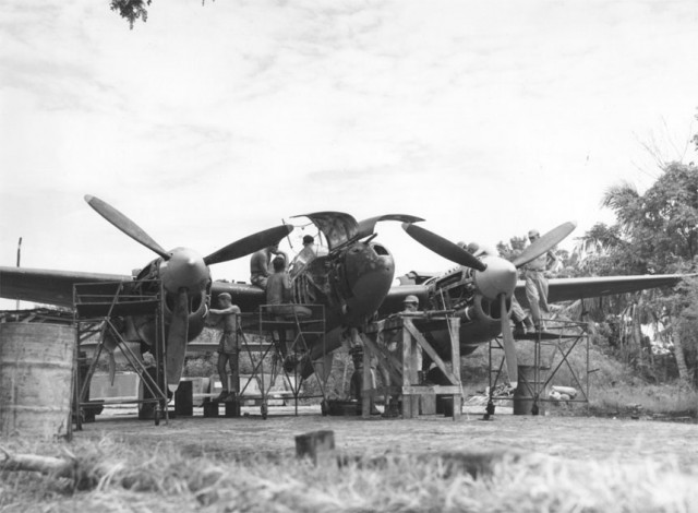 Ground crew members of the 459th Fighter Squadron, nicknamed the "Twin Dragon Squadron", working on a Lockheed P-38 at an air base in Chittagong, India - January 1945. (72611 A.C.) .