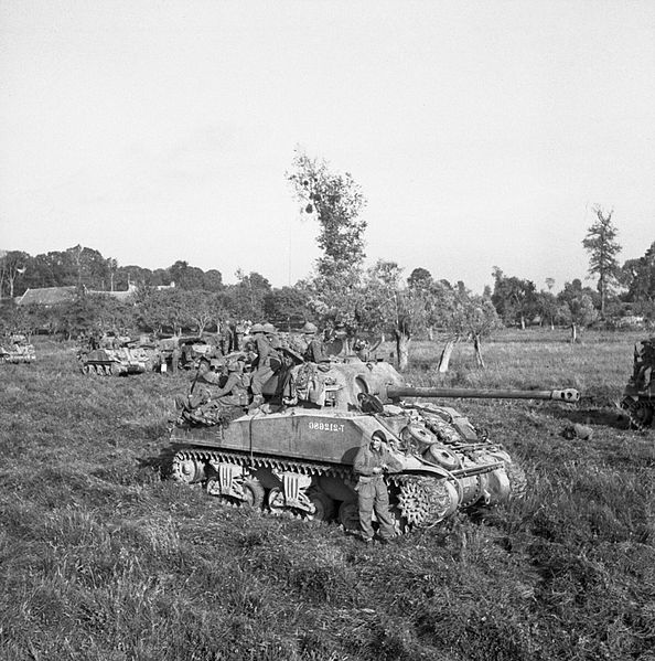 British infantry and Sherman tanks wait to advance at the start of Operation 'Goodwood', Normandy, 18 July 1944. B7513