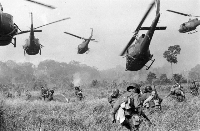 http://galleryhip.com/green-berets-1960s.html US soldiers on patrol in Vietnam covered by helicopters