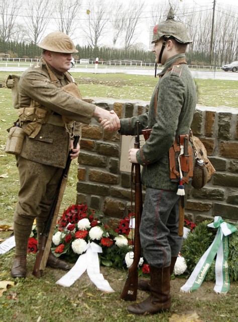 Peter Knight and Stefan Langheinrich, descendants of WWI soldiers, shake hands on 11 November 2008 at the Christmas Truce monument in Frelinghien, France to reenact the event