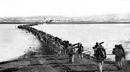Chinese forces cross the Yalu River.