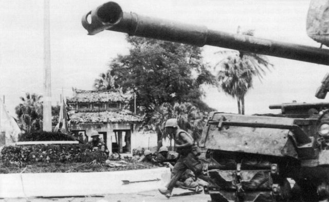 U.S. Marines advance past an M48 Patton tank during the battle for Huế.