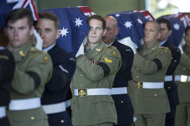 Australian Defence Force personnel from Australias Federation Guard carry the coffins of the 33 Australian service personnel and dependants to the hearses at the end of the repatriation ceremony at RAAF Base Richmond in Sydney on Thursday, 02 June 2016. *** Local Caption *** Two Royal Australian Air Force C-17A Globemaster aircraft touched down at RAAF Base Richmond today at 10.30am to return home to Australia the remains of 33 Australian service personnel and dependents, many of whom were casualties of the Vietnam War, from cemeteries in Malaysia and Singapore. The Governor-General of Australia, His Excellency General the Hon. Sir Peter Cosgrove (Retd), AK, MC; Minister for Defence, Senator the Hon. Marise Payne, representing the Prime Minister; Chief of the Australian Defence Force, Air Chief Marshal Mark Binskin, AC; and Chief of Army, Lieutenant General Angus Campbell, DSC, AM; joined family and friends for a military repatriation ceremony. Australian Defence Force personnel from Australias Federation Guard and other units escorted the remains of the 33 Service personnel and dependants from the RAAF aircraft into a memorial service with family and friends, before the 33 hearses left RAAF Base Richmond. The repatriation, being organised by the Office of Australian War Graves, is one of the largest single repatriations of Australian service personnel and dependents in our history. On 25 May 2015, the Australian Government offered to repatriate 36 Australian service personnel and dependants from Terendak Military Cemetery in Malaysia and Kranji Cemetery in Singapore. The families of 33 service personnel and dependents accepted the offer.