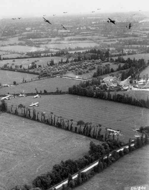 Gliders are delivered to the Cotentin Peninsula by Douglas C-47 Skytrains. 6 June 1944 (Image).