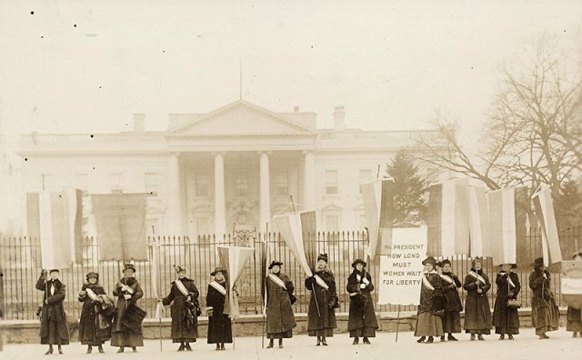 Suffragettes in 1917 protesting against Wilson's stance on women's votes The sign on the right reads: "Mr. President How Long Must Women Wait for Liberty"