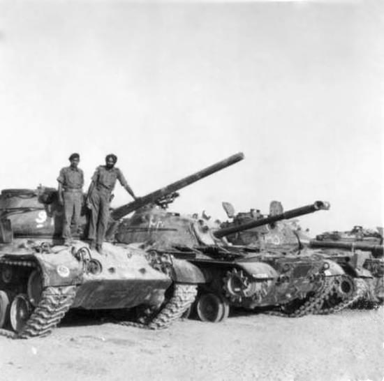 Indian troops standing on destroyed/captured Patton tanks.