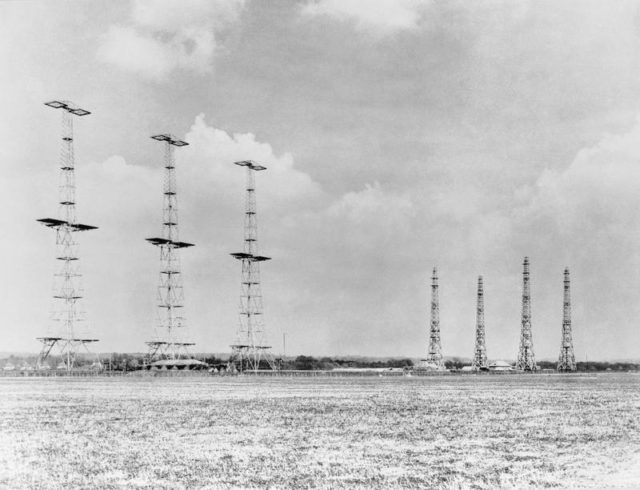 AMES Type 1 CH East Coast radar installation at Poling, Sussex. On the left are three (originally four) in-line 360ft steel transmitter towers, between which the transmitter aerials were slung, with the heavily protected transmitter building in front. On the right are four 240ft wooden receiver towers placed in rhombic formation, with the receiver building in the middle. [© IWM (CH 15173)]