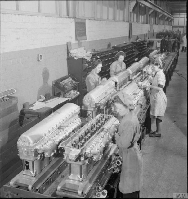 Female workers attach the Induction Manifolds to the Cylinder Blocks, prior to the Blocks being fitted to the engine, at this aircraft engine factory somewhere in Britain. [© IWM (D 12131)]