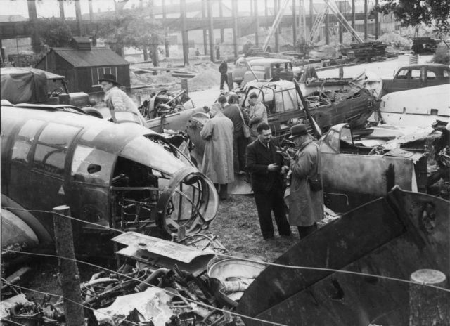 Reporters examine the remains of a Heinkel He 111, Junkers Ju 87 and Messerschmitt Bf 109E, now resting in a scrapyard in Britain, 2nd October 1940. [© IWM (HU 104723)]