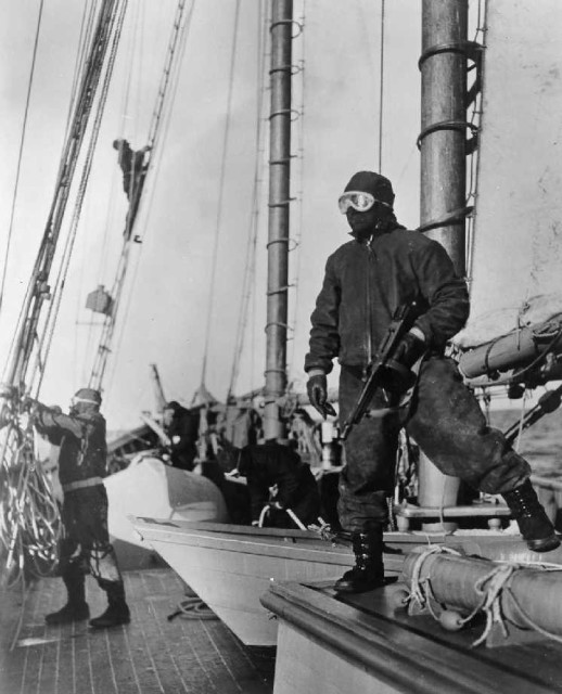 Sailor in foul weather gear with a Thompson sub machine gun. Courtesy of USCG.mil