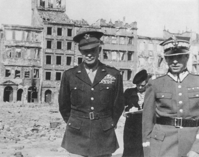 General Dwight Eisenhower during his visit in Warsaw, capital of Poland. Picture taken on the Old Town Square, destroyed in 1944 by German forces after supression of Warsaw Uprising (1944). Right, General Marian Spychalski.
