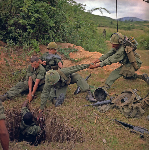 Soldiers seen pulling a tunnel rat out of a tunnel during Vietnam. 