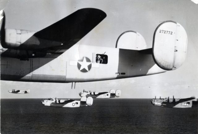  Consolidated B-24D-155-CO Liberator 42-72772 and flight cross the Mediterranean Sea at very low level, 1 August 1943. A gunner stands in the waist position. The bomber’s belly turret is retracted. [U.S. Air Force / Public Domain]