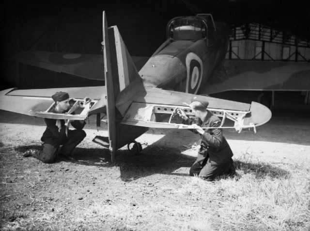 Ground crew from No. 264 inspect the damage to a Defiant's elevators. This plane had just returned from the amazingly successful sorties of May 29th, 1940. When 264 Squadron shot down 37 German aircraft, without a single loss. Source: wiki/ public domain.
