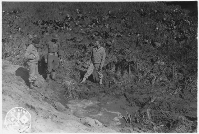 American servicemen inspecting a shell crater after the Japanese attack on Fort Stevens, Oregon. Wikipedia / Public Domain