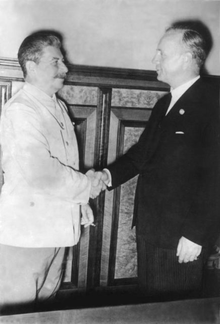 Soviet Premier Joseph Stalin and German foreign minister Joachim von Ribbentrop shaking hands over the Nazi-Soviet Pact (also known as the Molotov-Ribbentrop Pact) on August 23, 1939 Image Source: Bundesarchiv, Bild 183-H27337 / CC-BY-SA 3.0