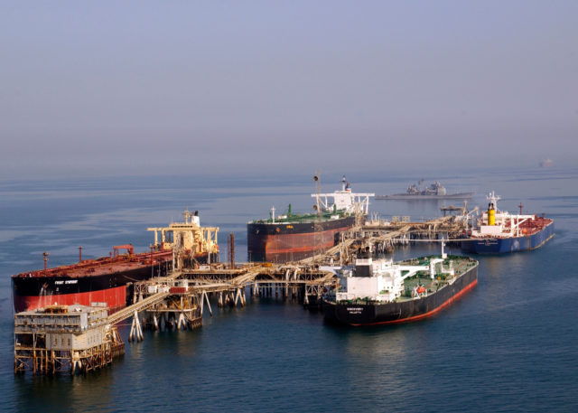 The Al Basra oil terminal , with a US Navy cruiser patrolling in the background. This and her sister terminal, Khawr al Almyra, provided the majority of Iraq's export wealth. Image Source: Wikimedia Commons/ Public Domain