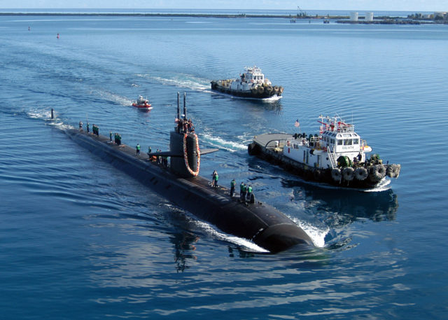 The attack submarine USS San Francisco (SSN 711) is escorted by two harbor tugs returns to Apra Harbor, Guam, after a five-month deployment.