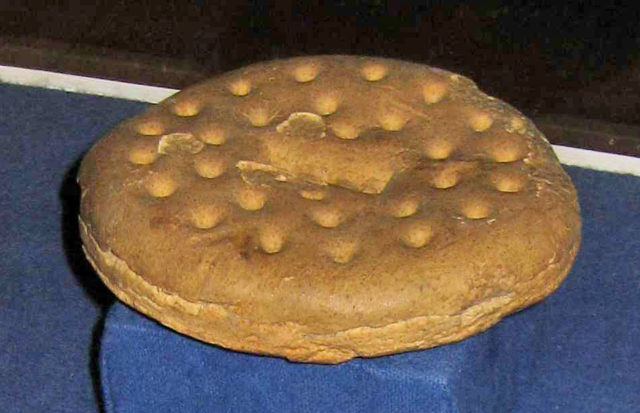 A simple ship's biscuit, made with just water and flour. These were baked multiple times to remove any trace of moisture, allowing them to last even longer. London made biscuits were considered the best the world over. Image Source: Wikimedia Commons/ By Paul A. Cziko, CC BY 2.5, https://commons.wikimedia.org/w/index.php?curid=22172272