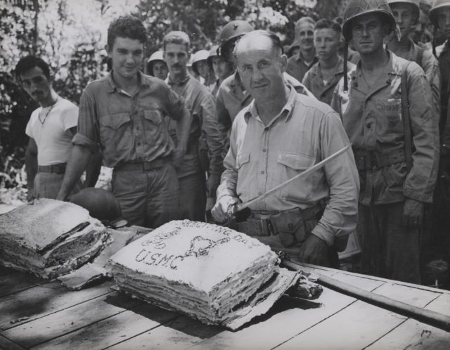 USMC Lieutenant Colonel W. W. Stickney preparing to cut a Thanksgiving holiday cake with a captured Japanese sword, Guadalcanal, Solomon Islands, circa 26 Nov 1942.