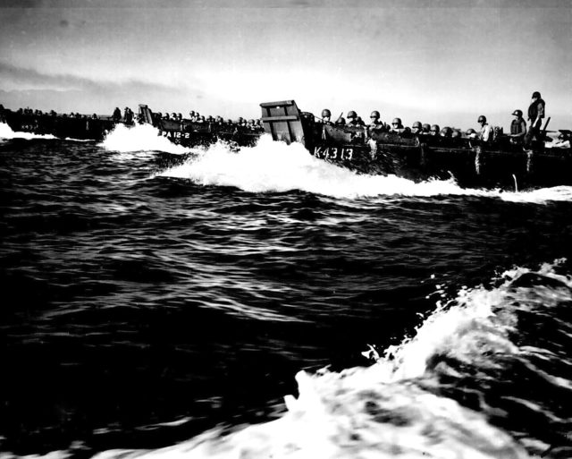 Coast Guard manned landing craft rush towards the shore, packed with US Army infantry. They're about to retake the Philippines. Image Source: Wikimedia Commons/ Public Domain