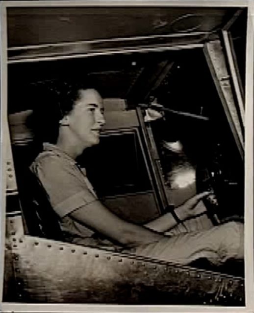 Cornelia posing in a plane cockpit Photo Credit