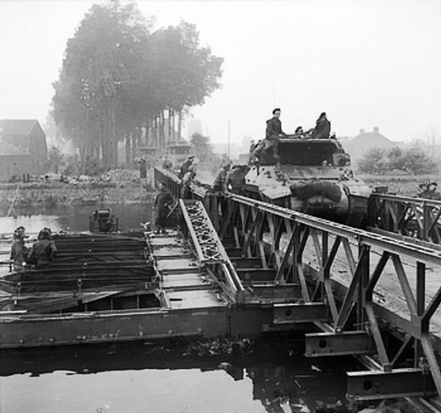 An M10 tank destroyer crosses the bailey bridge near Son. 