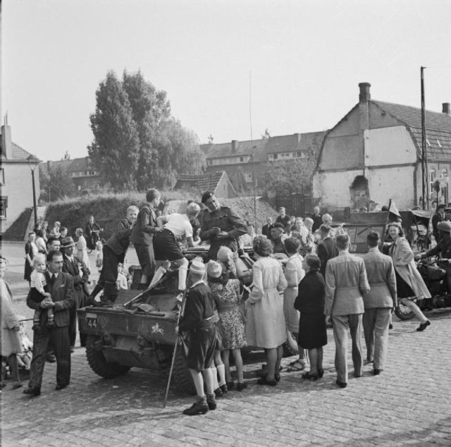 XXX Corps troops attempting to pass through Grave, captued by the 82nd. They were immediately greeted by elated civilians, which further slowed progress. Image Source: Wikimedia Commons/ public domain
