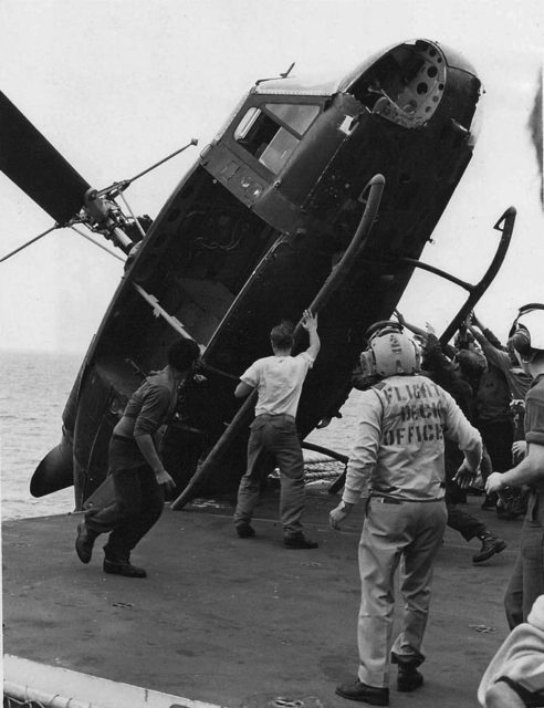 A South Vietnamese helicopter that ferried two South Vietnamese officers, a woman, and two children being pushed off the USS Okinawa to make room for more arriving choppers in April 1975 Photo Credit