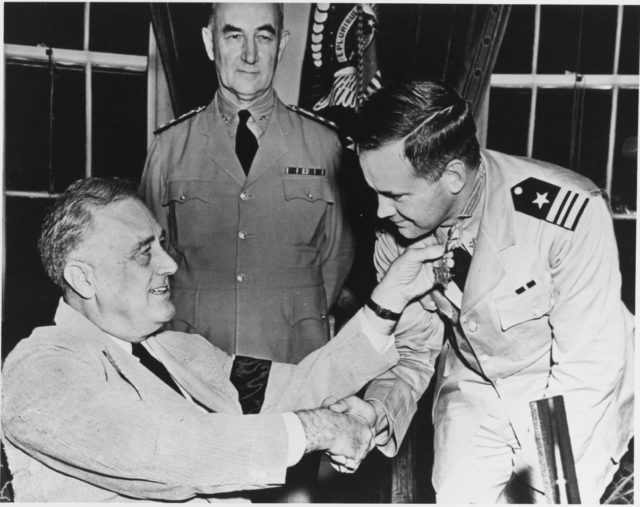 Lieutenant Commander John D. Bulkeley receiving his Medal of Honor from President Roosevelt.