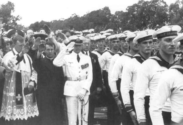 Captain Hans Langsdorff salutes fallen shipmates at a funeral held for victims of the battle, once safely in Montevideo