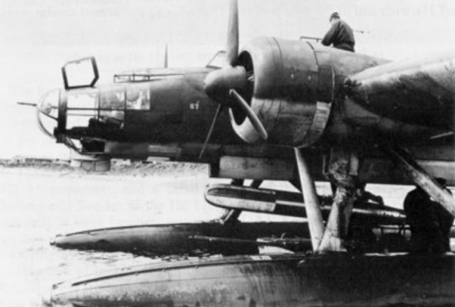 A torpedo is loaded on a German Heinkel He 115 seaplane.