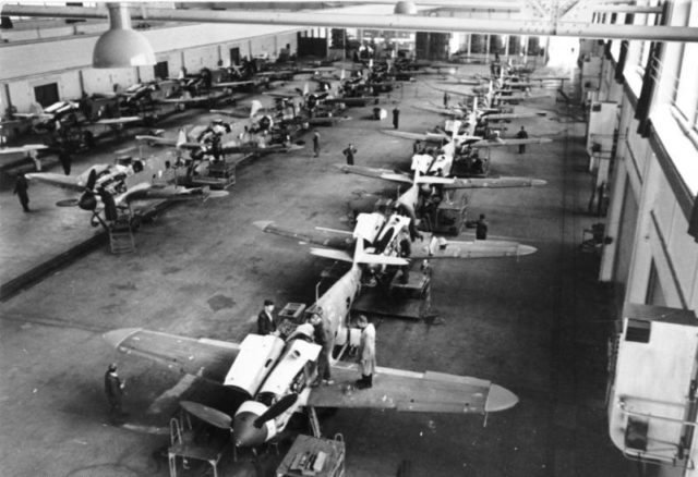 Assembly of Bf 109G-6s in a German aircraft factory. By Bundesarchiv – CC BY-SA 3.0 de