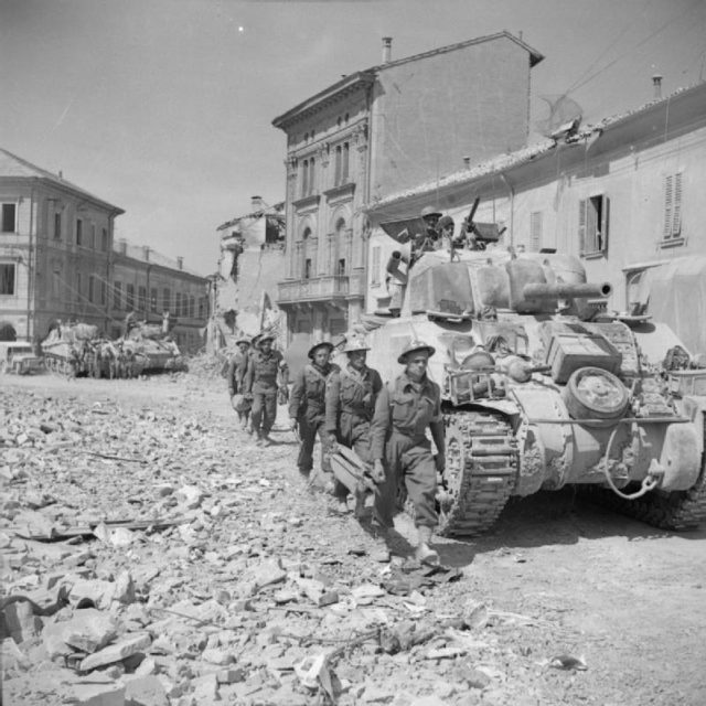 Men of the 8th Army entering Portomaggiore on their way to Bologna.