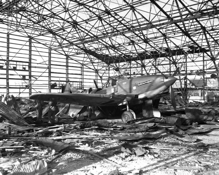 A North Korean Ilyushin Il-10 attack aircraft in a damaged hangar at Kimpo airfield, South Korea, on 21 September 1950.