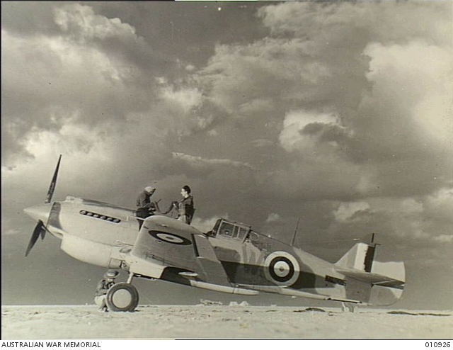 Armourers working on a Tomahawk fighter aircraft of No 3 Squadron RAAF. 23 December 1941, Western Desert, North Africa. Photo: AWM.
