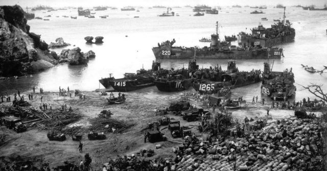 American ships landing troops and supplies on a beach on Okinawa, Japan, 13 April 1945.