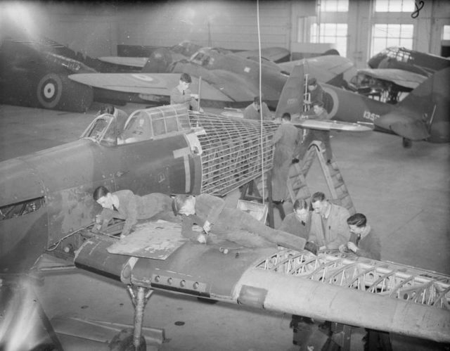 Trainee aircraft fitters working on instructional partly-assembled Hurricanes, circa 1939–1940.
