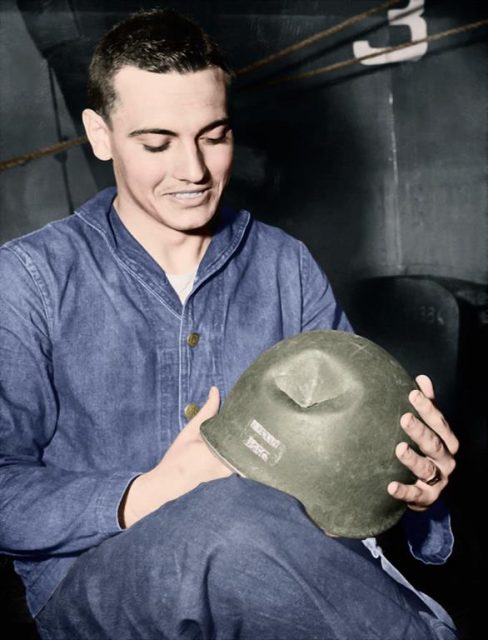 Coast Guardsman prizes his batteres war bonnet. It saved his life on the invasion beaches of France. He was knocked down when a Nazi 30 claiber machine gun bullet tore a two inch hole in his tin hat. He escaped the incident with a minor scratch to the head. Paul Reynolds / mediadrumworld.com