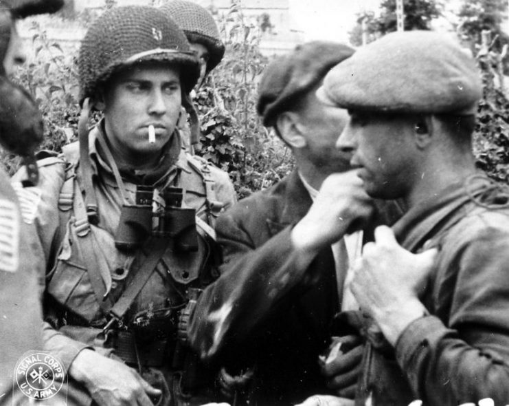 Member of the French Resistance and Allied paratroopers reporting on the situation during the Battle of Normandy in 1944.