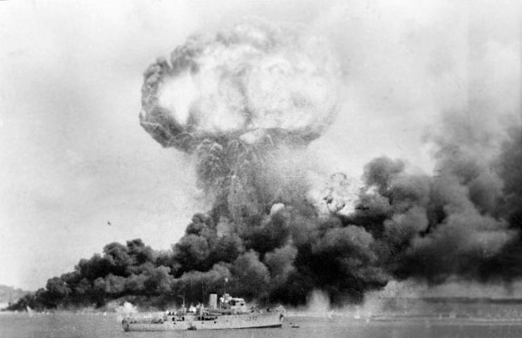1st Japanese attack on Darwin with MV Neptuna explosion. HMAS Deloraine is in the foreground undamaged.