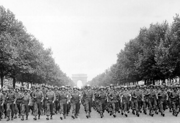 American troops of the 28th Infantry Division march down the Avenue des Champs-Élysées, Paris, in the `Victory’ Parade.