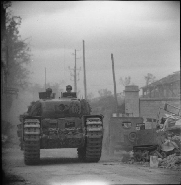 Churchill AVRE with 290mm Petard spigot mortar of 79th Armoured Division moving into Caen, 10 July 1944.