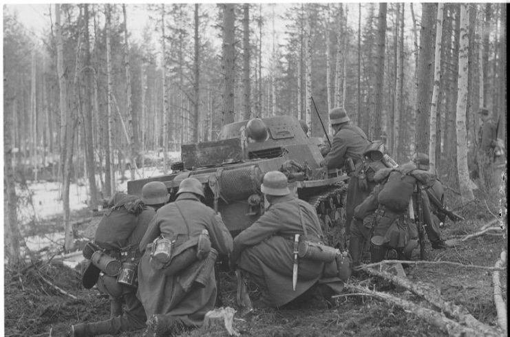 German Gebirgsjäger attacking behind Panzer cover at Jeletozero village in the Louhksky District, Soviet Union.