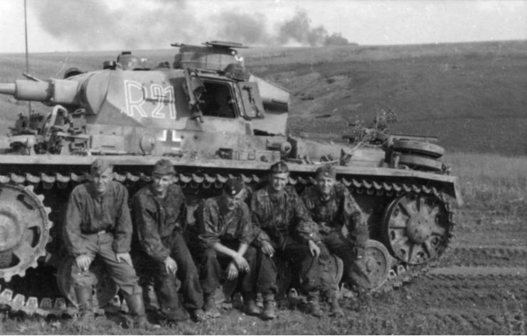 The crew of a Panzer III of the 2nd SS Panzer Division Das Reich rests during a lull in the Battle of Kursk on the Eastern Front. By Bundesarchiv – CC BY-SA 3.0 de