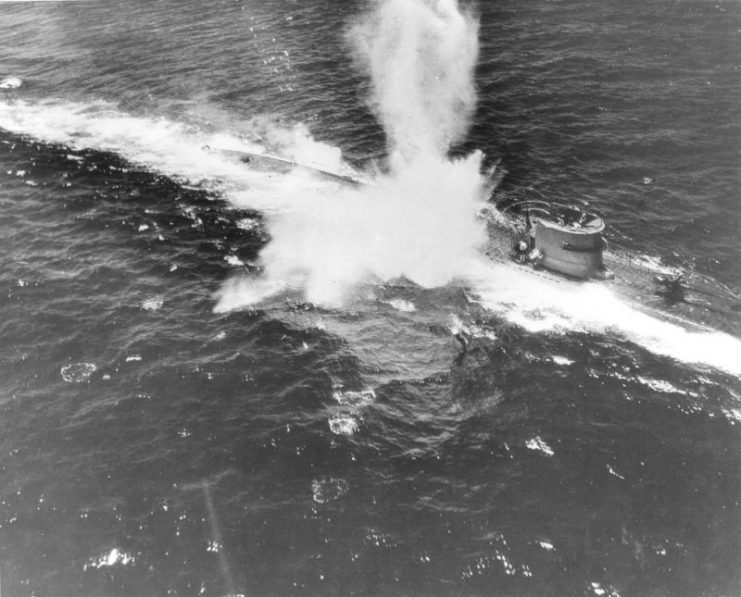 A German Type VII U-Boat in the Atlantic under aerial attack from US Navy aircraft flying from a hunter-killer group built around an Escort Carrier, early 1944.