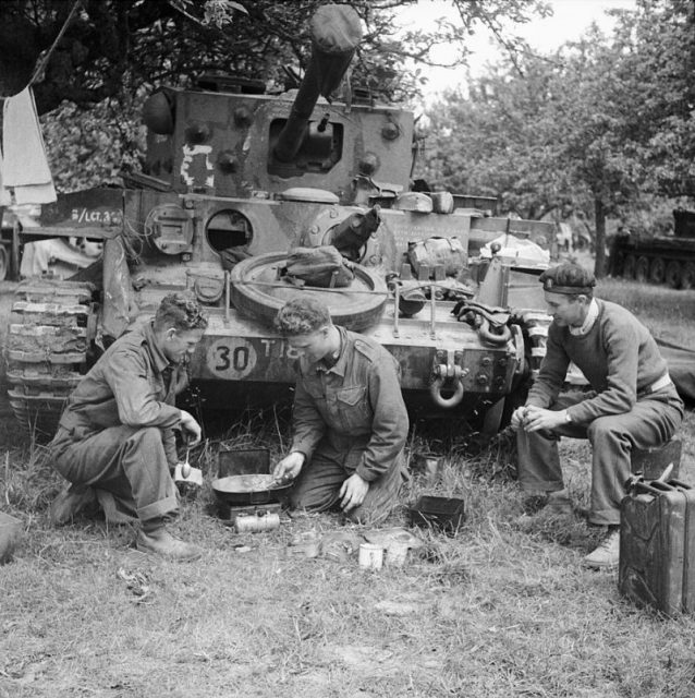 Allied tank crew preparing a meal in front of their vehicle, 17 June 1944