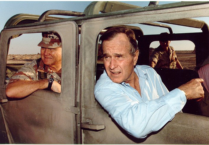 General Norman Schwarzkopf, Jr. and President George Bush visit US troops in Saudi Arabia on Thanksgiving Day, 1990.