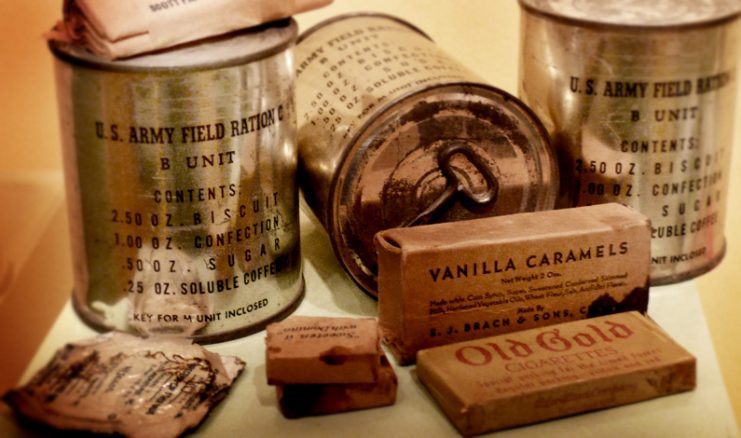 A selection of United States military C-Ration cans from World War II with items displayed.