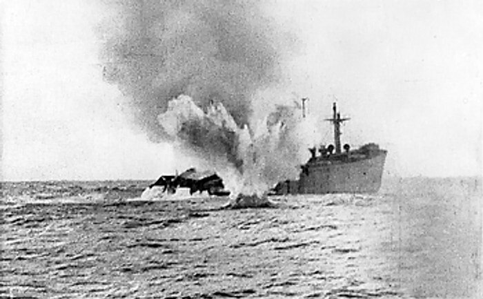 A torpedoed merchant ship sinking.
